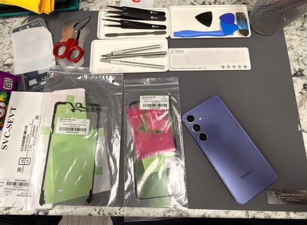 A broken iPhone screen being replaced